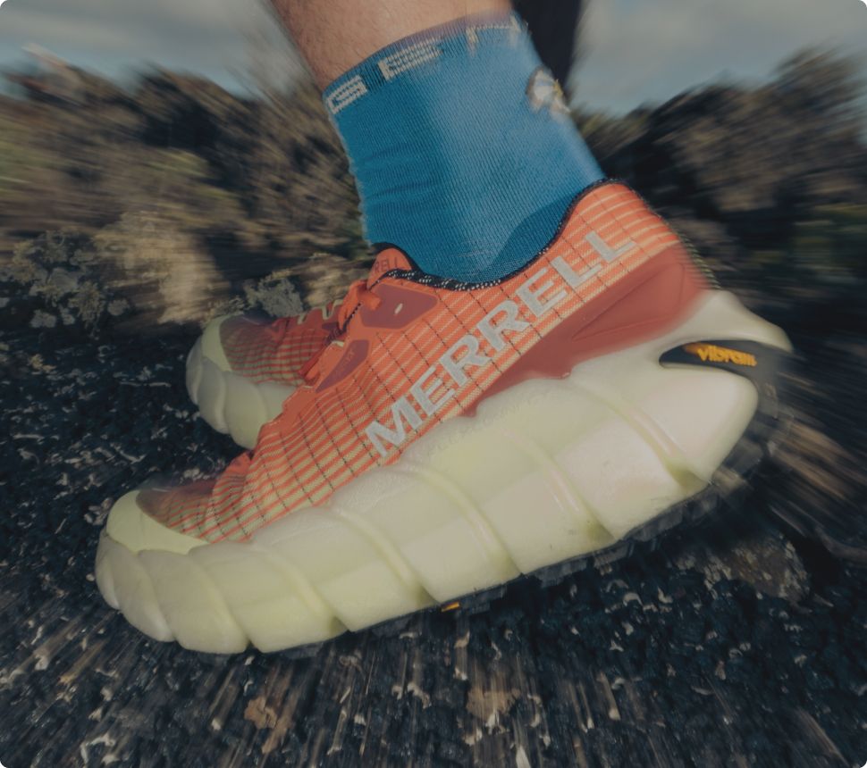 Person tying Merrell running shoes